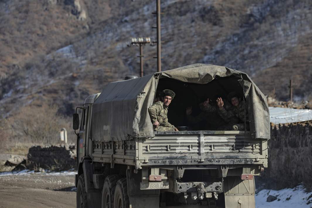 Азербайджанские военнослужащие сидят в военном грузовике на дороге к своему военному палаточному лагерю 