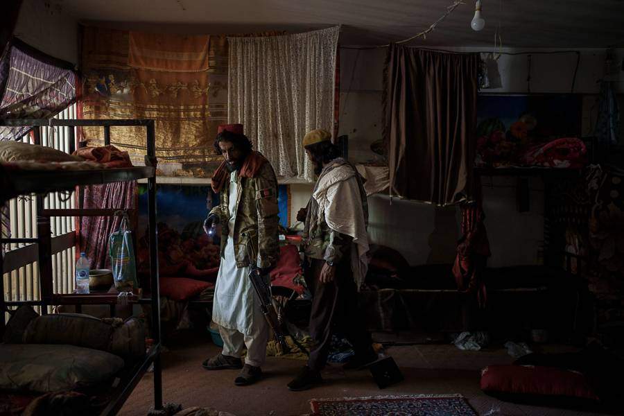 Taliban fighters walk inside an empty cell at the Pul-e-Charkhi prison in Kabul, Afghanistan, Monday, Sept. 13, 2021. (AP Photo/Felipe Dana)