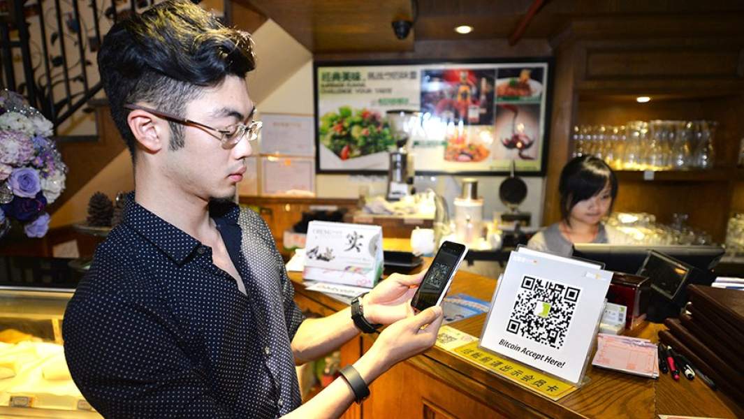 Клиент расплачивается биткоинами в кафе через приложение по QR-коду