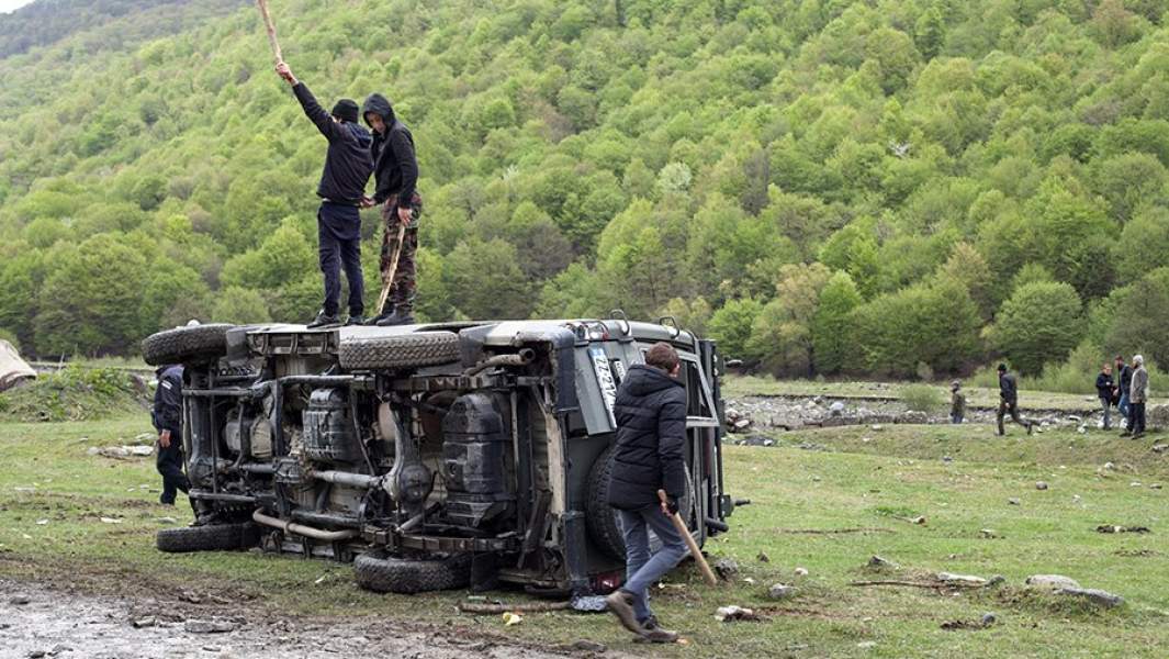 Протестующие на перевернутом автомобиле полиции