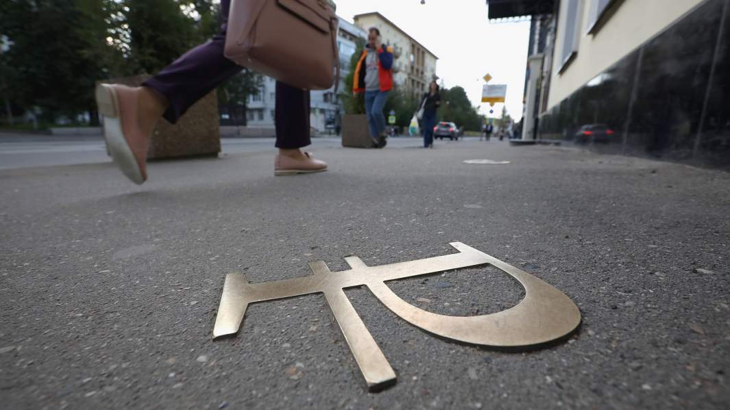 символ рубля на асфальте