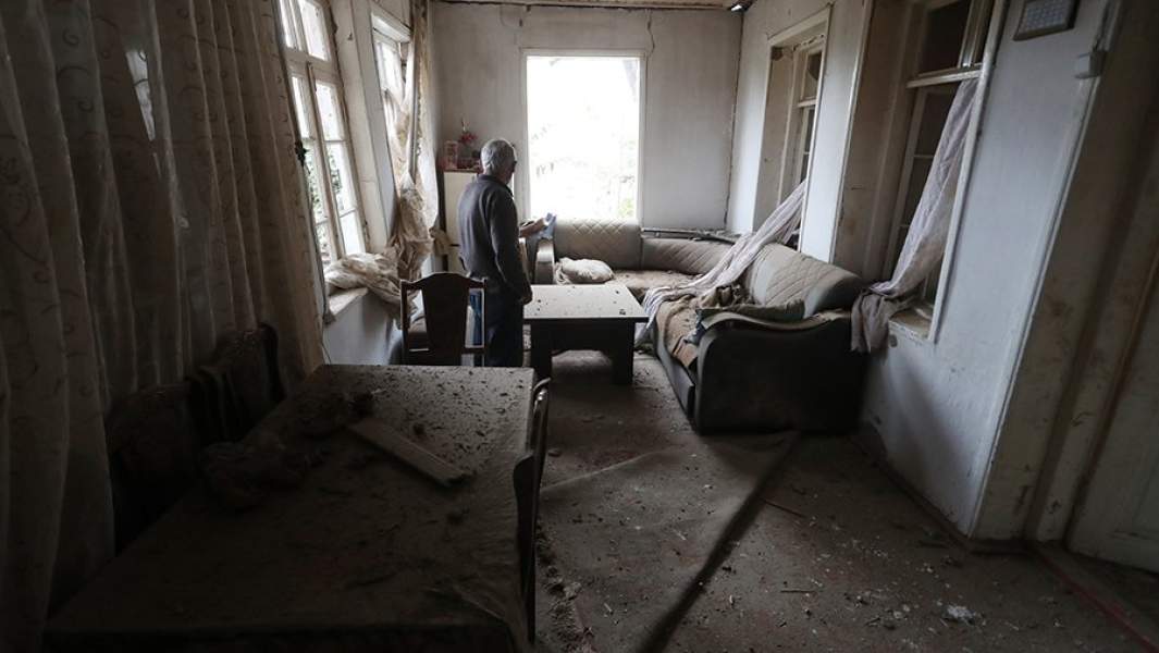 Мужчина в поврежденном в результате обстрела со стороны азербайджанских военных доме в городе Мартуни