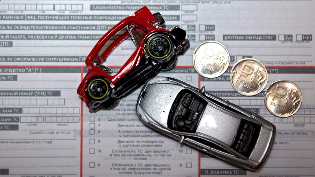 Столкнувшиеся игрушечные машинки на фоне полиса