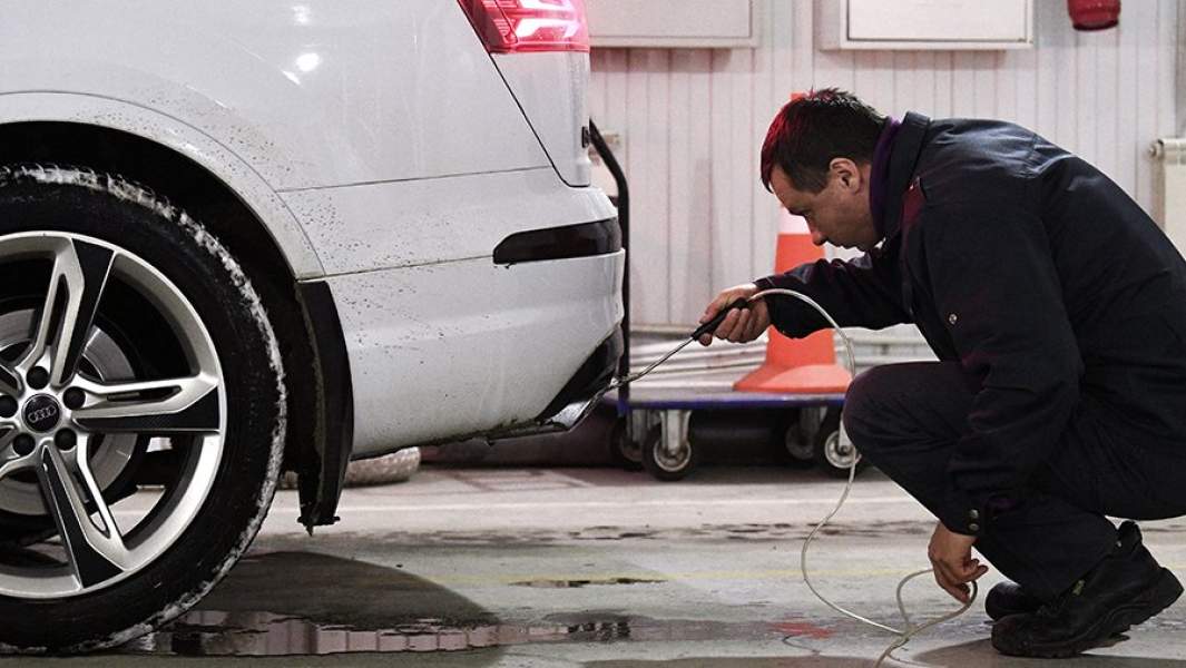 Технический эксперт проводит осмотр автомобиля