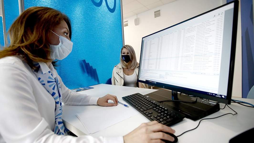 Карьерный консультант во время общения с посетительницей в центре занятости населения