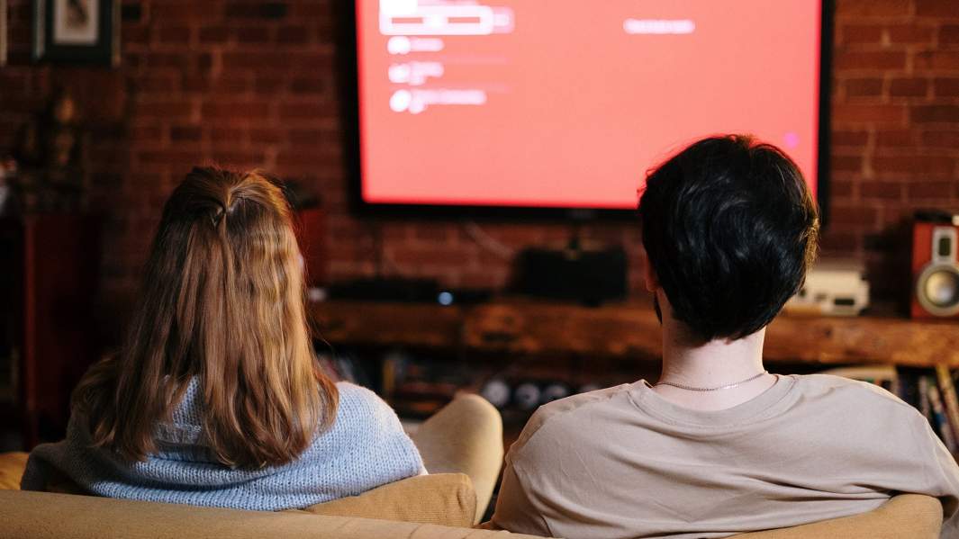 Парень с девушкой смотрят телевизор