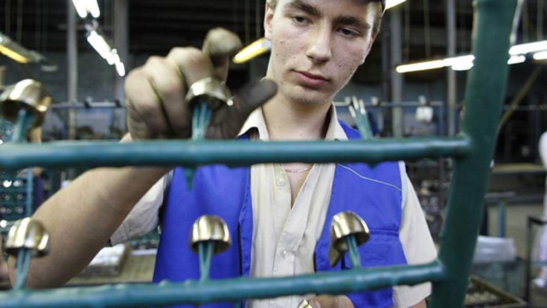Школьник работает на заводе по выпуску сантехнического оборудования