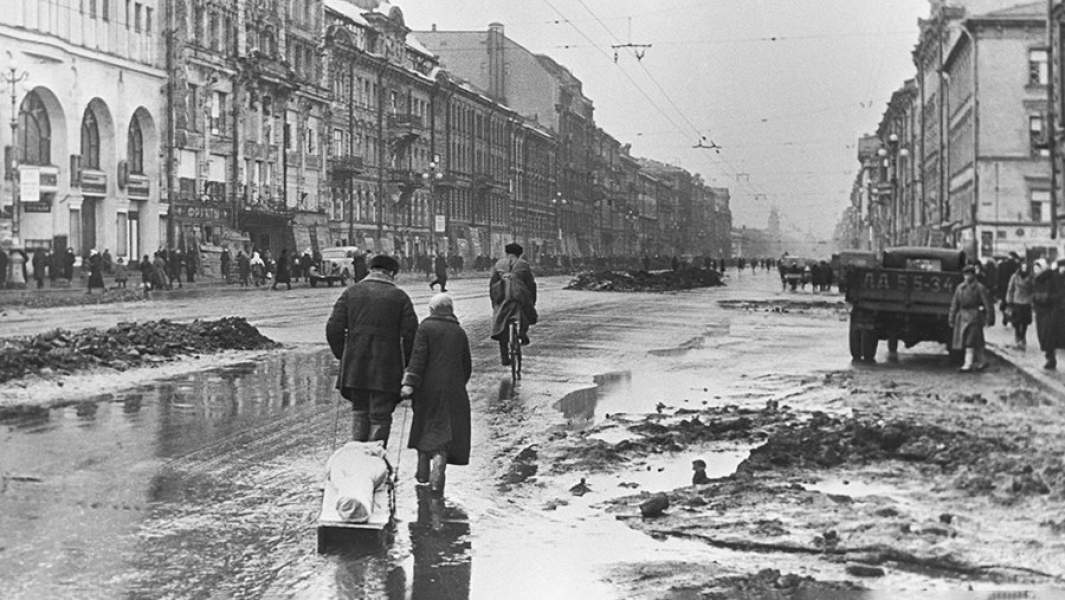 Жители блокадного Ленинграда везут на санках тело умершего