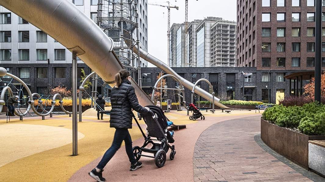 женщина с коляской во новом жилом квартале