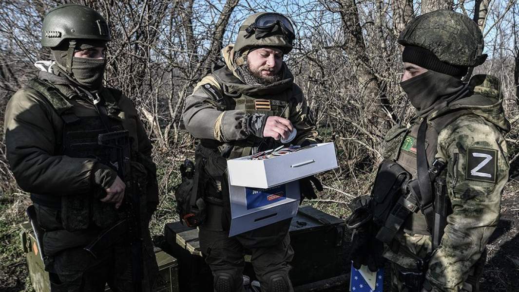 Корреспондент агентства РИА «Новости» Ростислава Журавлев раздает присланные шевроны бойцам на передовой, участвующим в боевых действиях на Запорожском направлении, декабрь 2022 года