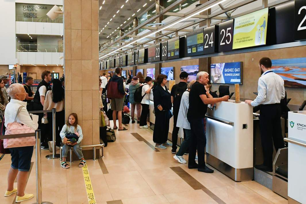 Пассажиры проходят регистрацию в аэропорту