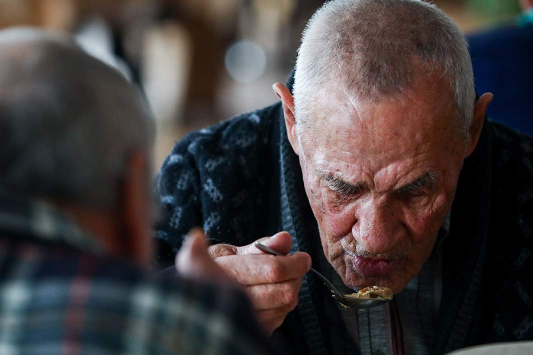 мужчина ест кашу