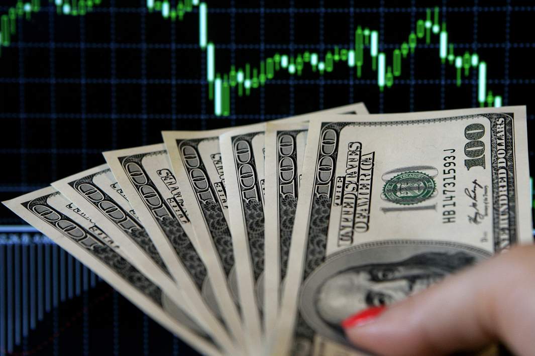 Доллары на фоне графика
