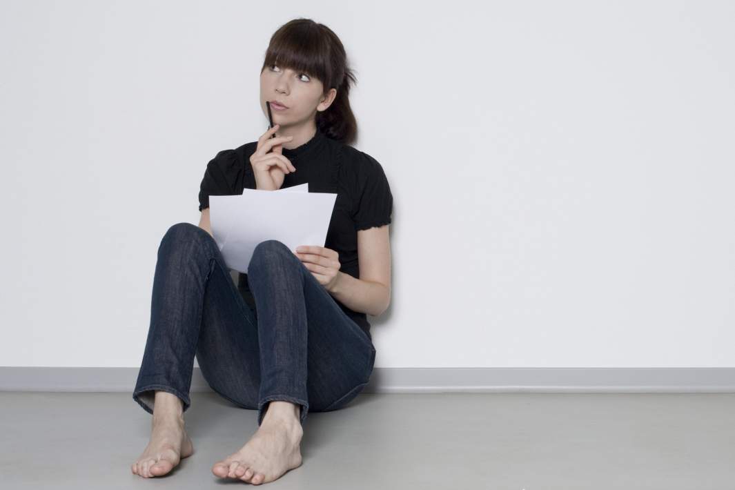 Женщина пишет на листке 