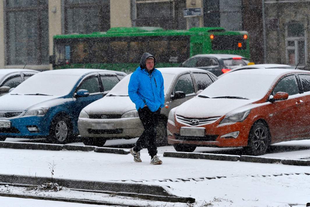 Мужчина идет по заснеженной улице