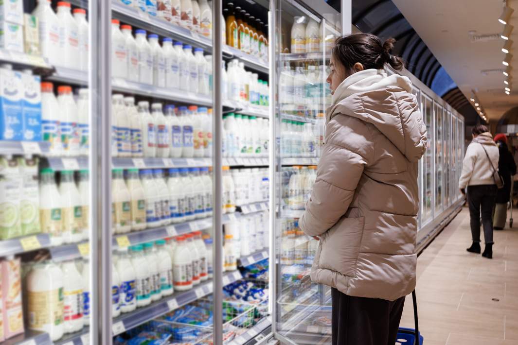 Девушка покупает молоко 