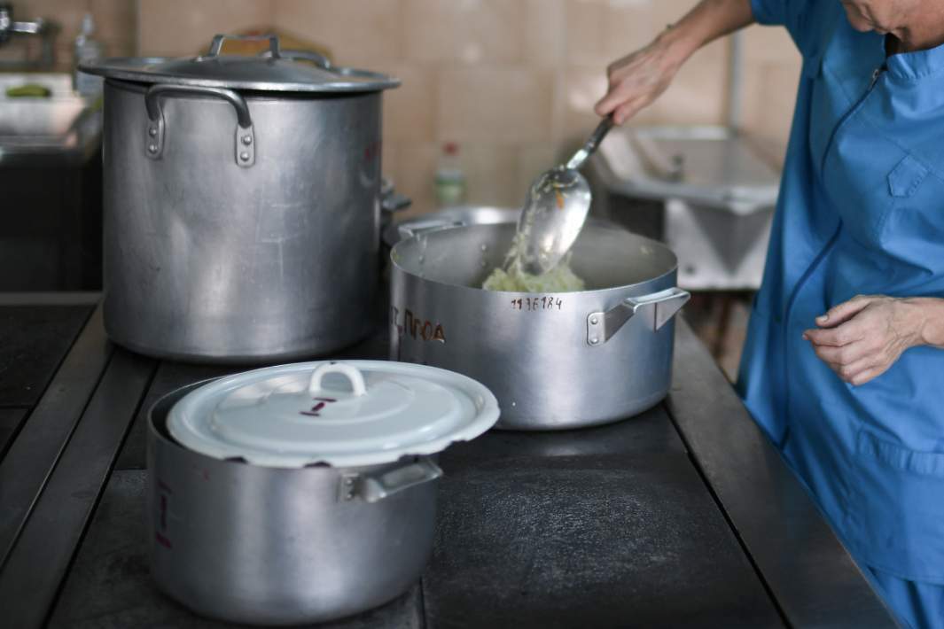 Повар накладывает еду 