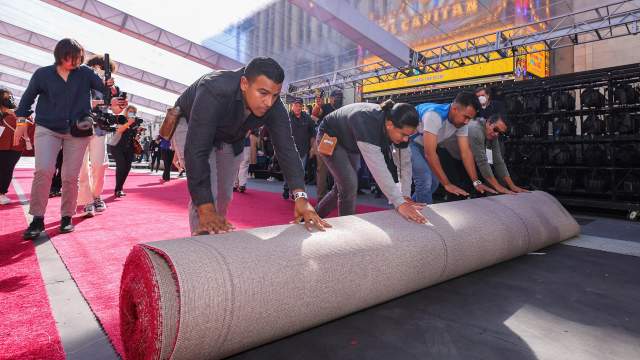 Workers roll out the red carpet on Hollywood Boulevard as preparations for the Academy Awards begin