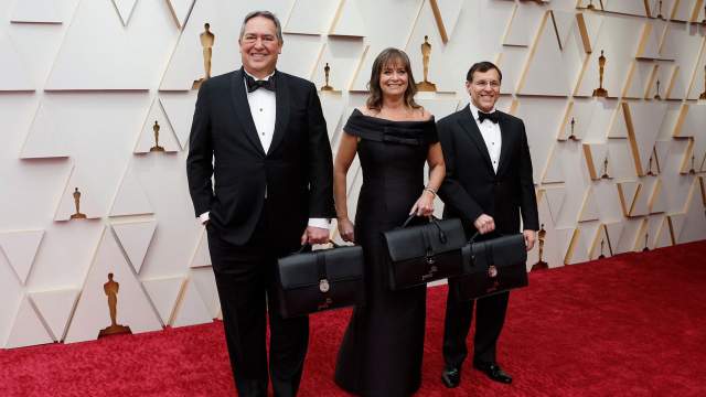 Accountants from PriceWaterhouseCoopers pose on the red carpet as they arrive with the results of the Oscars voting for the 94th Academy Awards in Hollywood
