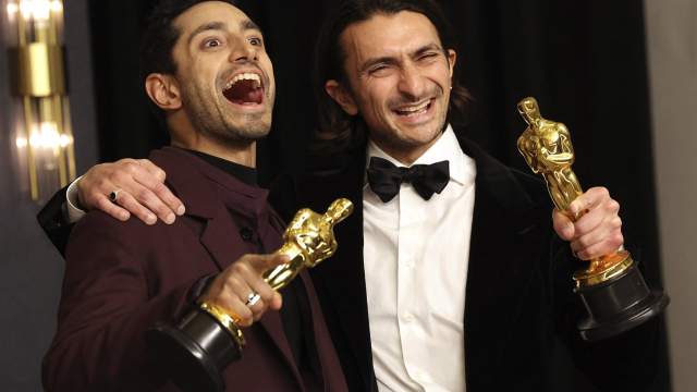Riz Ahmed and Aneil Karia take pictures as they pose with their Oscars for Best Live Action Short Film for "The Long Goodbye" in the photo room during the 94th Academy Awards in Hollywood