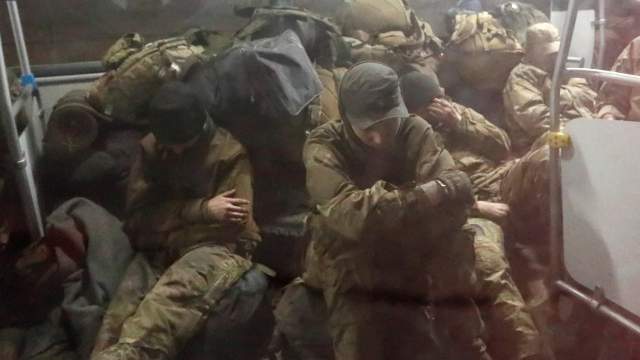 Service members of the Ukrainian armed forces, who surrendered at the besieged Azovstal steel mill in Mariupol in the course of Ukraine-Russia conflict, sit in a bus upon their arrival under escort of the pro-Russian military in the settlement of Olenivka in the Donetsk region
