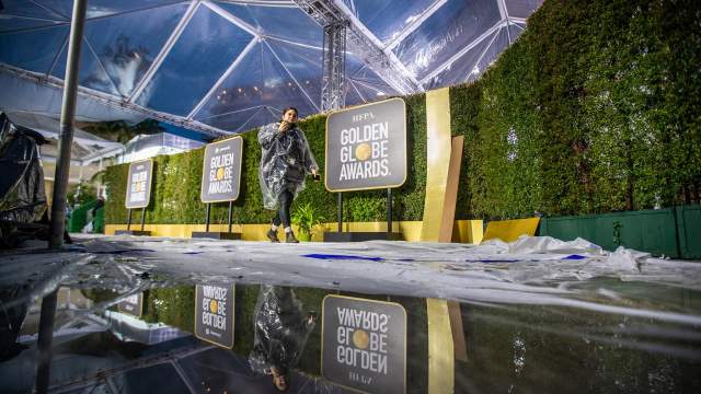 Amidst rain showers, crews are reflected in pools of water as they set up the red carpet for the 80th Golden Globe Awards at The Beverly Hilton