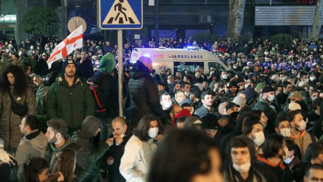 An ambulance drives amid protesters during a rally against the "foreign agents" law in Tbilisi, Georgia, March 7