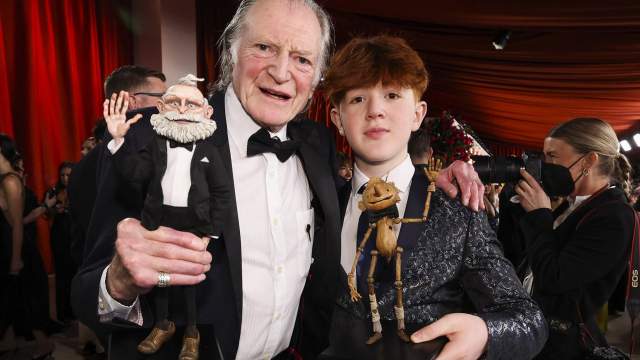 Actors David Bradley and Gregory Mann pose on the champagne-colored red carpet during the Oscars arrivals at the 95th Academy Awards in Hollywood, Los Angeles