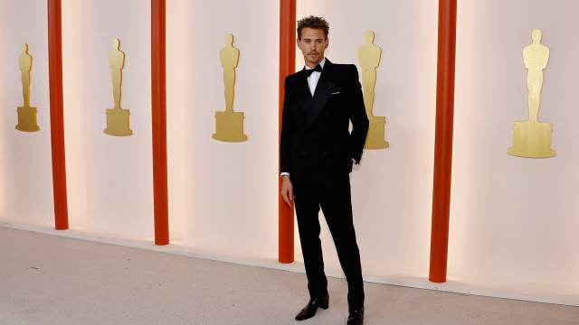 Austin Butler poses on the champagne-colored red carpet during the Oscars arrivals at the 95th Academy Awards in Hollywood, Los Angeles, California, U.S
