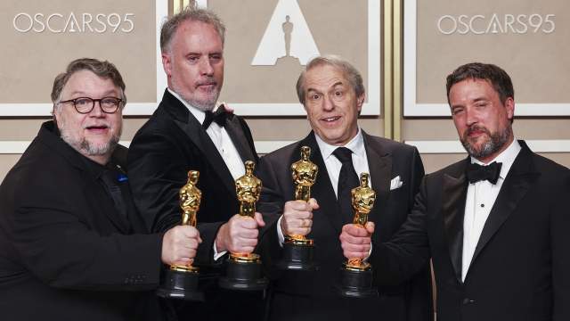 Guillermo del Toro, Mark Gustafson, Gary Ungar and Alex Bulkley pose with the Oscar for Best Animated Feature Film for "Guillermo del Toro's Pinocchio" in the Oscars photo room at the 95th Academy Awards in Hollywood