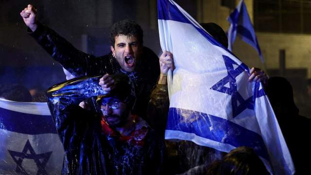People attend a demonstration after Israeli Prime Minister Benjamin Netanyahu dismissed the defense minister and his nationalist coalition government presses on with its judicial overhaul, in Jerusalem