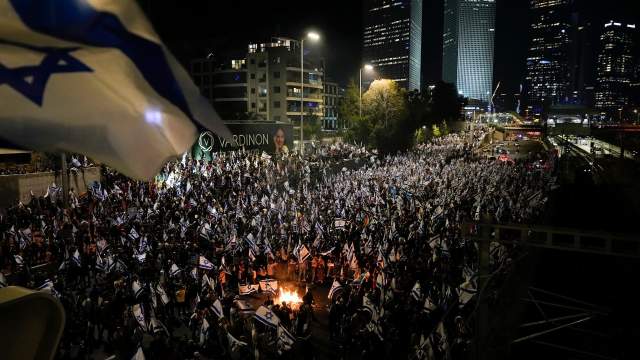 Israelis opposed to Prime Minister Benjamin Netanyahu's judicial overhaul plan set up bonfires and block a highway during a protest moments after the Israeli leader fired his defense minister, in Tel Aviv, Israel, Sunday, March 26, 2023. Defense Minister Yoav Gallant had called on Netanyahu to freeze the plan, citing deep divisions in the country and turmoil in the military