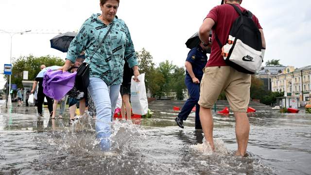Прохожие на подтопленной улице в результате ливня в Москве