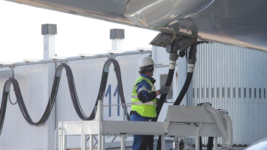 Man refuelling plane from underside