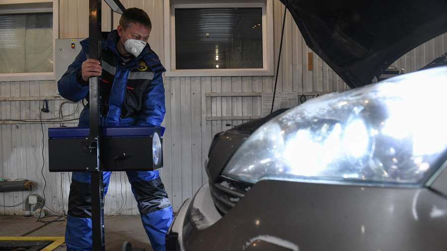 A technical expert inspects the car