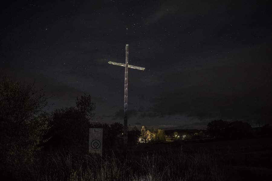 Деревянный крест освещен факелом на Пути Святого Иакова, или Эль Камино де Сантьяго