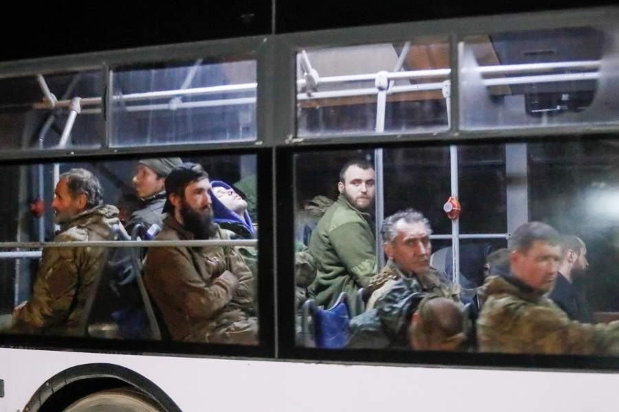 A bus carrying service members of the Ukrainian armed forces, who surrendered at the besieged Azovstal steel mill, drives away under escort of the pro-Russian military in the course of Ukraine-Russia conflict in Mariupol