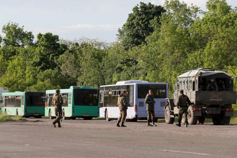 Buses carrying service members of the Ukrainian armed forces, who surrendered at the besieged Azovstal steel mill, are seen on the roadside while driving under escort of the pro-Russian military in the course of Ukraine-Russia conflict near Mariupol