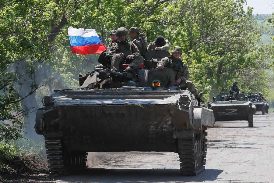 A convoy of Russian armoured vehicles drives along a road in the course of Ukraine-Russia conflict near Mariupol in the Donetsk region