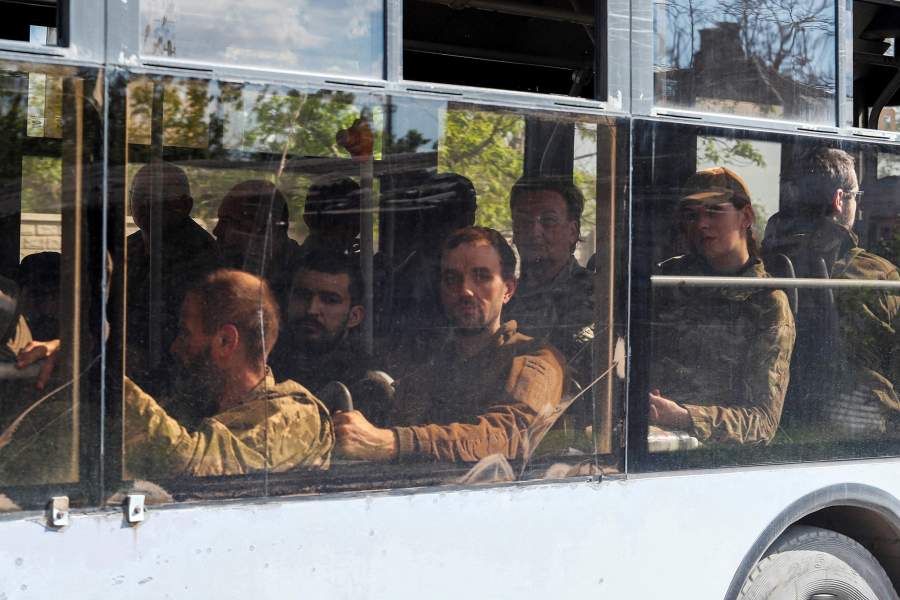 A bus carrying service members of the Ukrainian armed forces, who surrendered at the besieged Azovstal steel mill, drives away under escort of the pro-Russian military in the course of the Ukraine-Russia conflict, in Mariupol