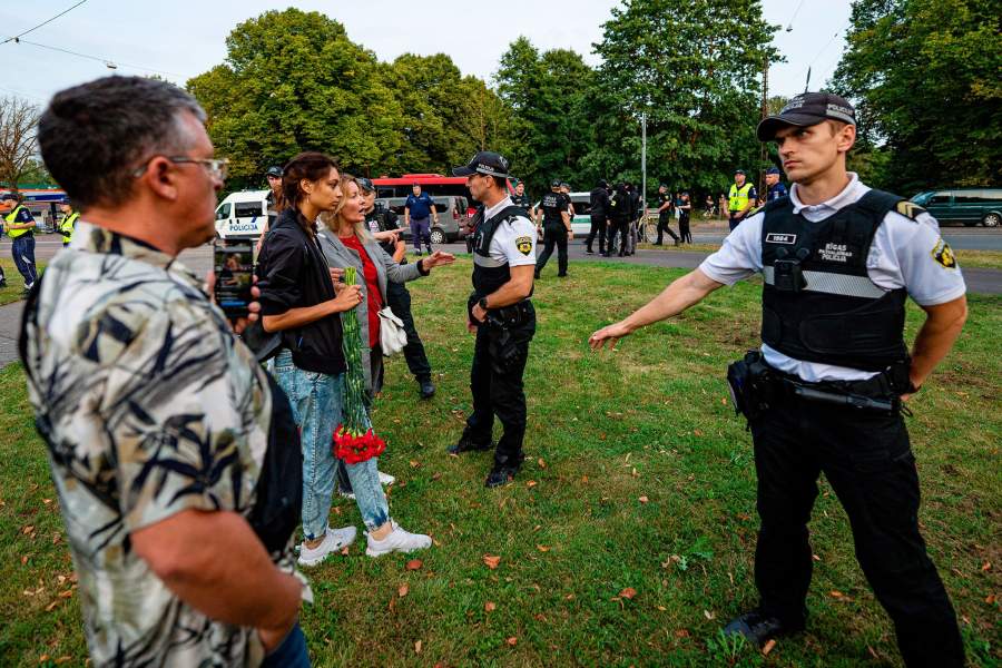 Сотрудники полиции стоят в оцеплении неподалеку от памятника воинам Советской Армии - освободителям Советской Латвии и Риги от немецко-фашистских захватчиков в парке Победы в Риге