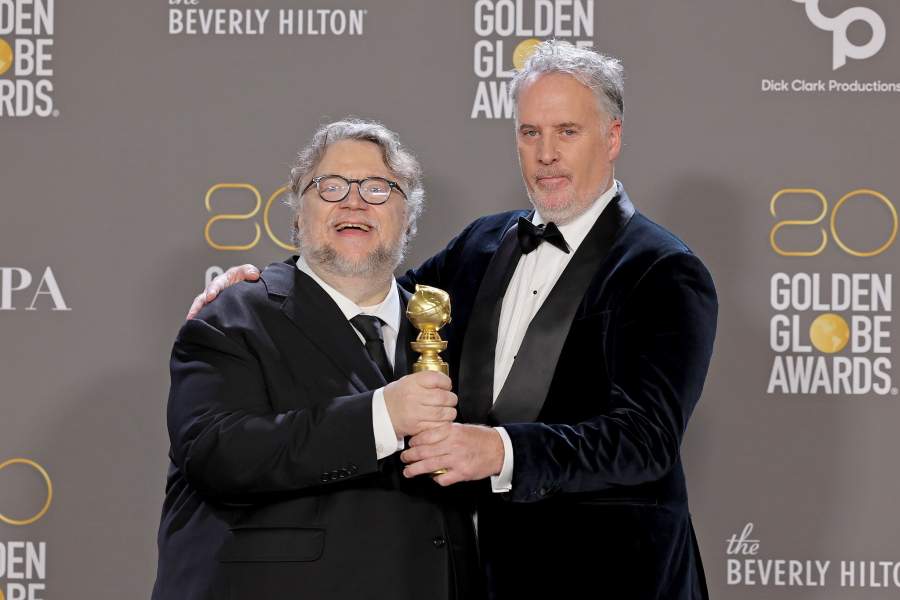 Guillermo del Toro and Mark Gustafson pose with the award for Best Animated Feature for "Guillermo del Toro's Pinocchio" in the press room during the 80th Annual Golden Globe Awards at The Beverly Hilton 