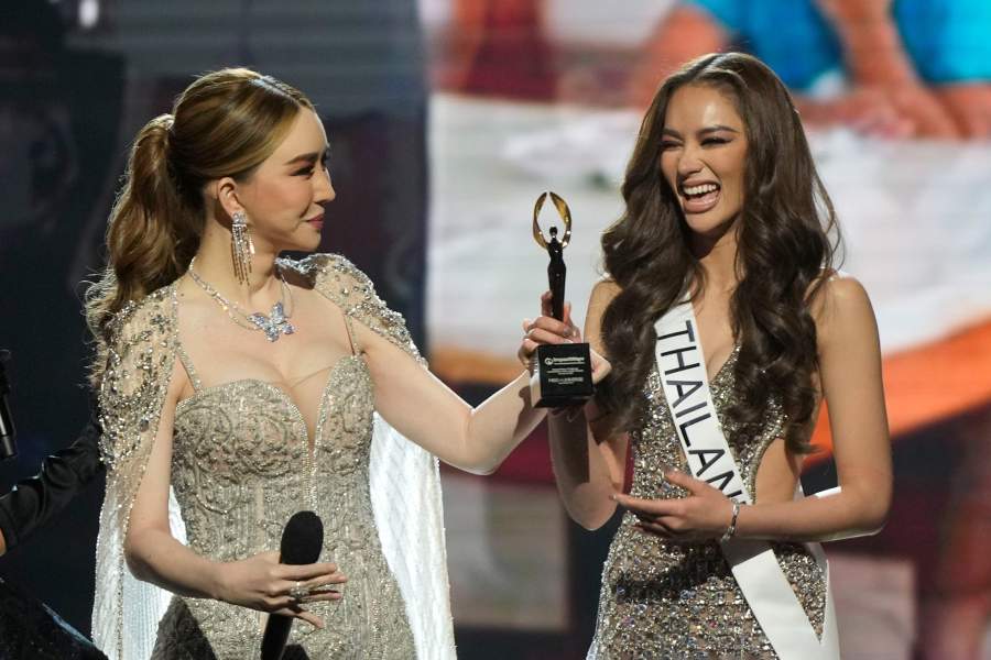 Anne Jakkaphong Jakrajutatip, the new owner of the Miss Universe Organization, presents the ImpactWayv Challenge Award to Miss Thailand Anna Sueangam-iam during the final round of the 71st Miss Universe Beauty Pageant in New Orleans