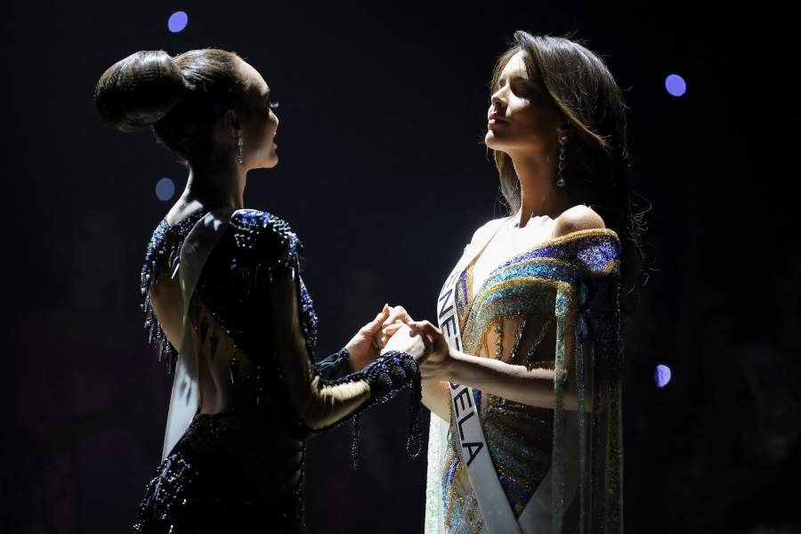 Miss U.S. R'Bonney Gabriel and Miss Venezuela Amanda Dudamel hold hands as they compete during the 71st Miss Universe pageant