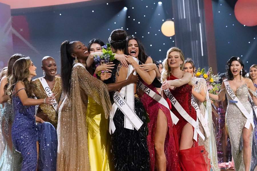 Miss USA R'Bonney Gabriel, back to camera, is hugged by other contestants after being crowned Miss Universe at the 71st Miss Universe pageant