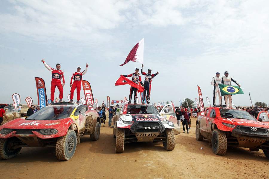 Rallying - Dakar Rally - Stage 14 - Al-Hofuf to Dammam - Saudi Arabia - January 15, 2023 Toyota Gazoo Racing's Nasser Al-Attiyah and co-driver Mathieu Baumel pose as they celebrate winning the car category with second placed Bahrain Raid Xtreme's Sebastien Loeb and co-driver Fabian Lurquin and third placed Overdrive Racing's Lucas Moraes and co-driver Timo Gottschalk 