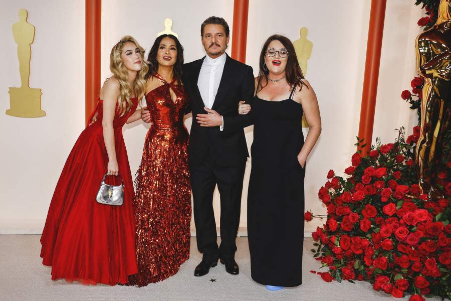Pedro Pascal, Salma Hayek and her daughter Valentina Paloma Pinault pose on the champagne-colored red carpet during the Oscars arrivals at the 95th Academy Awards in Hollywood, Los Angeles, California