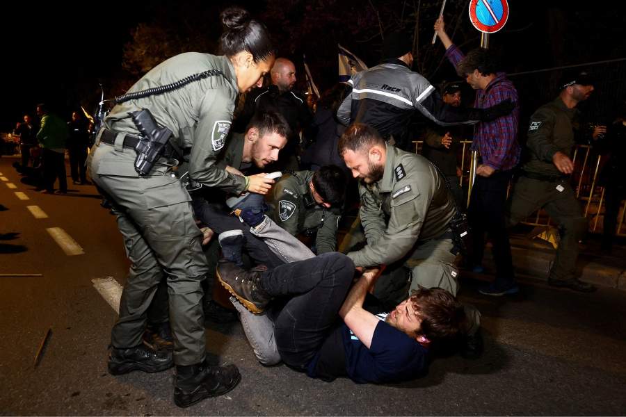 Police officers detain a protester during a demonstration after Israeli Prime Minister Benjamin Netanyahu dismissed the defense minister and his nationalist coalition government presses on with its judicial overhaul, in Jerusalem