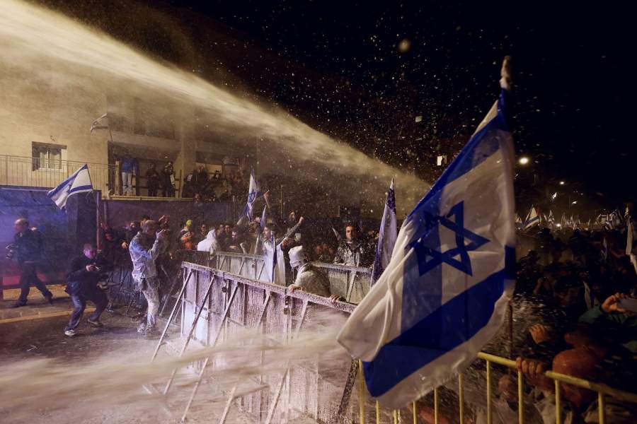 People take part in a demonstration after Israeli Prime Minister Benjamin Netanyahu dismissed the defense minister and his nationalist coalition government presses on with its judicial overhaul, in Jerusalem
