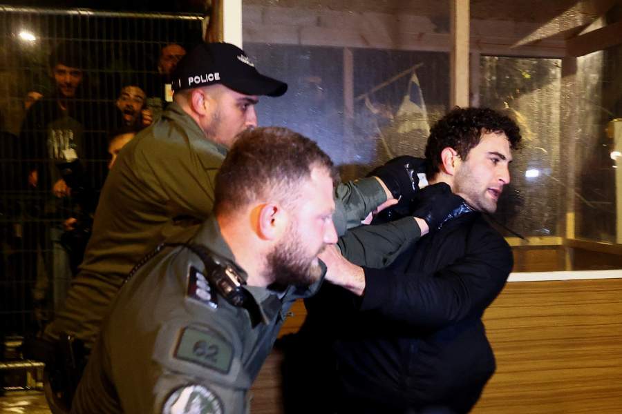 Police officers detain a protester during a demonstration after Israeli Prime Minister Benjamin Netanyahu dismissed the defense minister and his nationalist coalition government presses on with its judicial overhaul, in Jerusalem